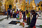 Yangon Myanmar. Shwedagon Pagoda (the Golden Stupa). Some fervent believers sweep some square meters of the pagoda, and symbolically washing their sins. 